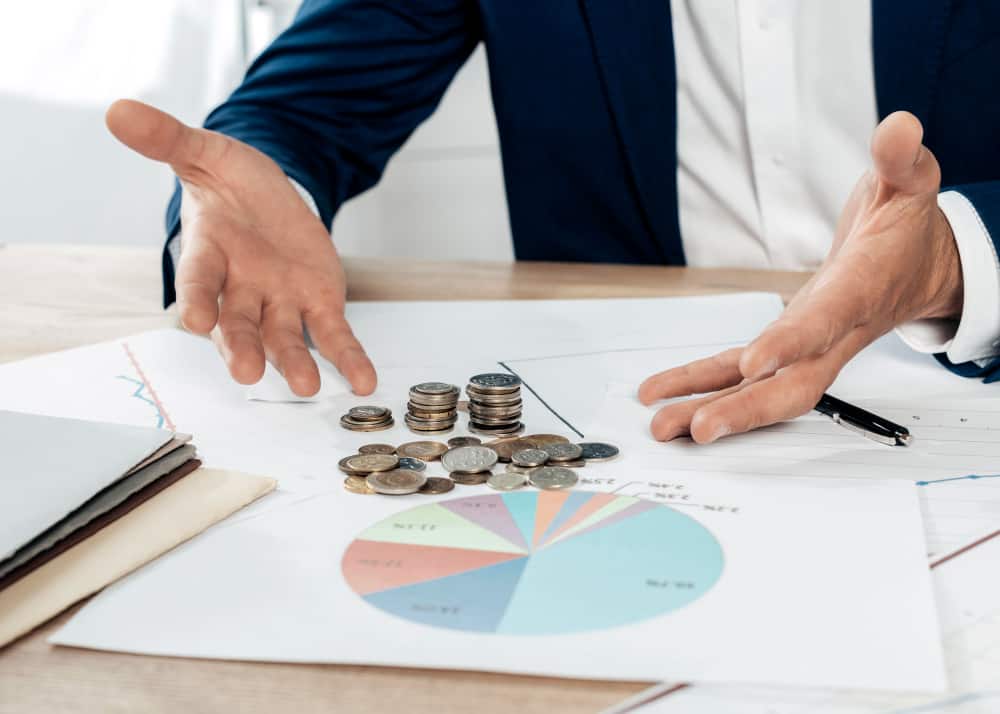 close-up-man-with-coins-statistics